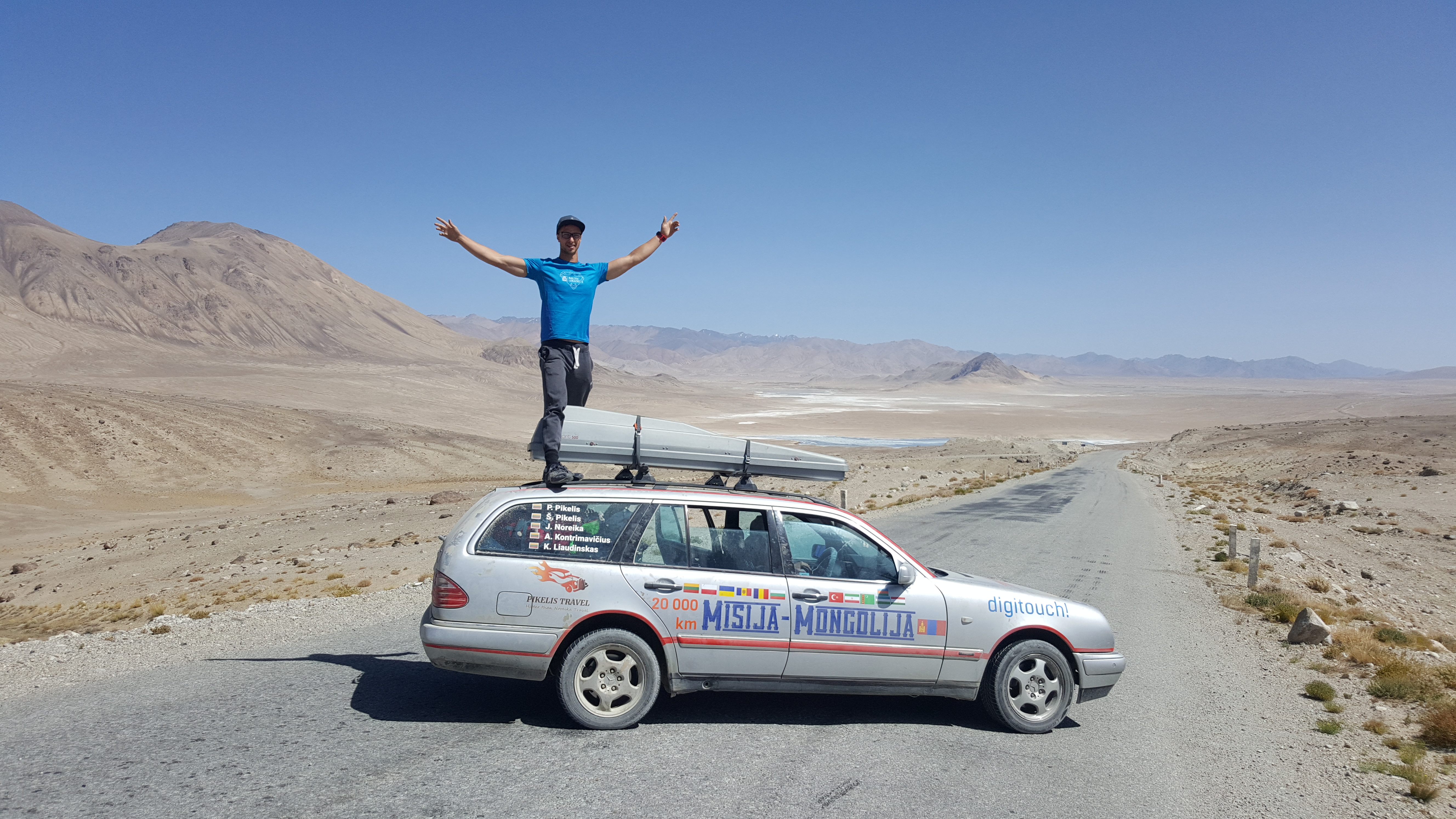 Convoy vehicles on a long-distance rally stage across open terrain